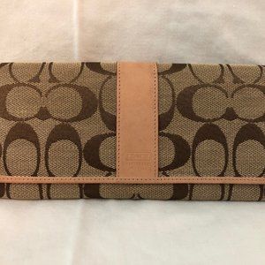 Cream and tan Coach Signature wallet with orange